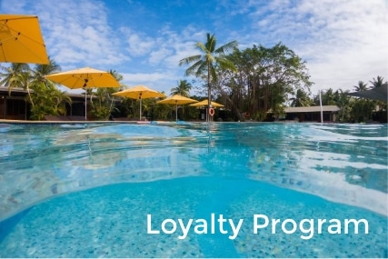 A pool and and a umbrella with portable folding bed with a word Loyalty program