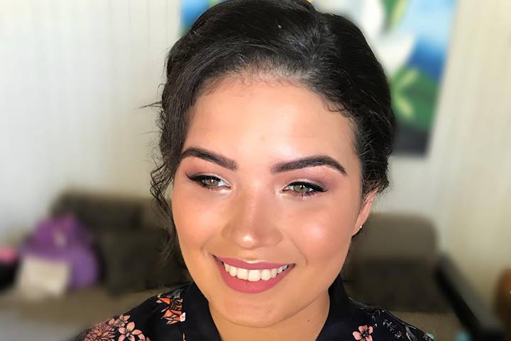 A woman face smile in front of the camera with makeup