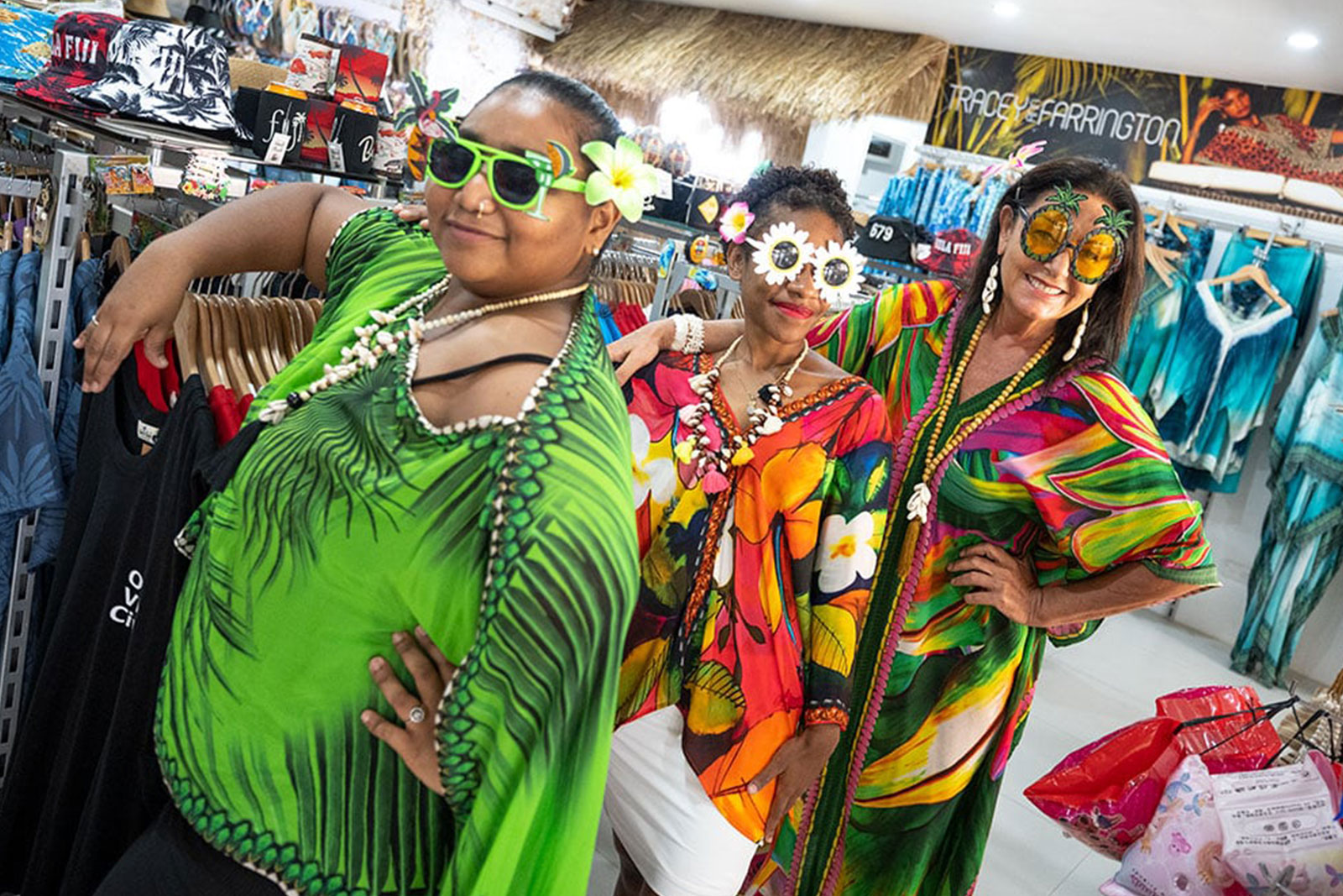 Three women wearing Hawaiian outfit.