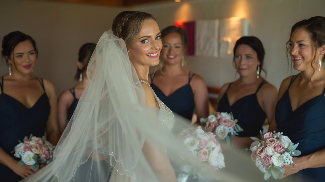 A group of women and a bride smiles