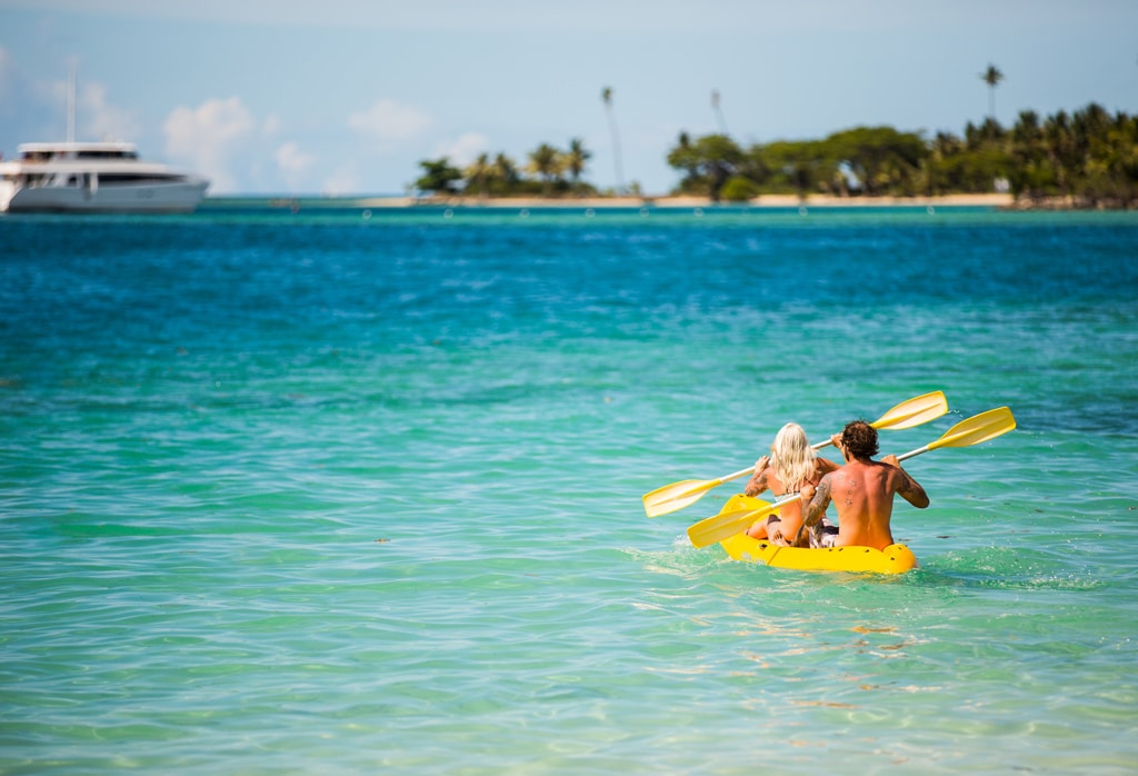 A couple riding kayak and a nature background