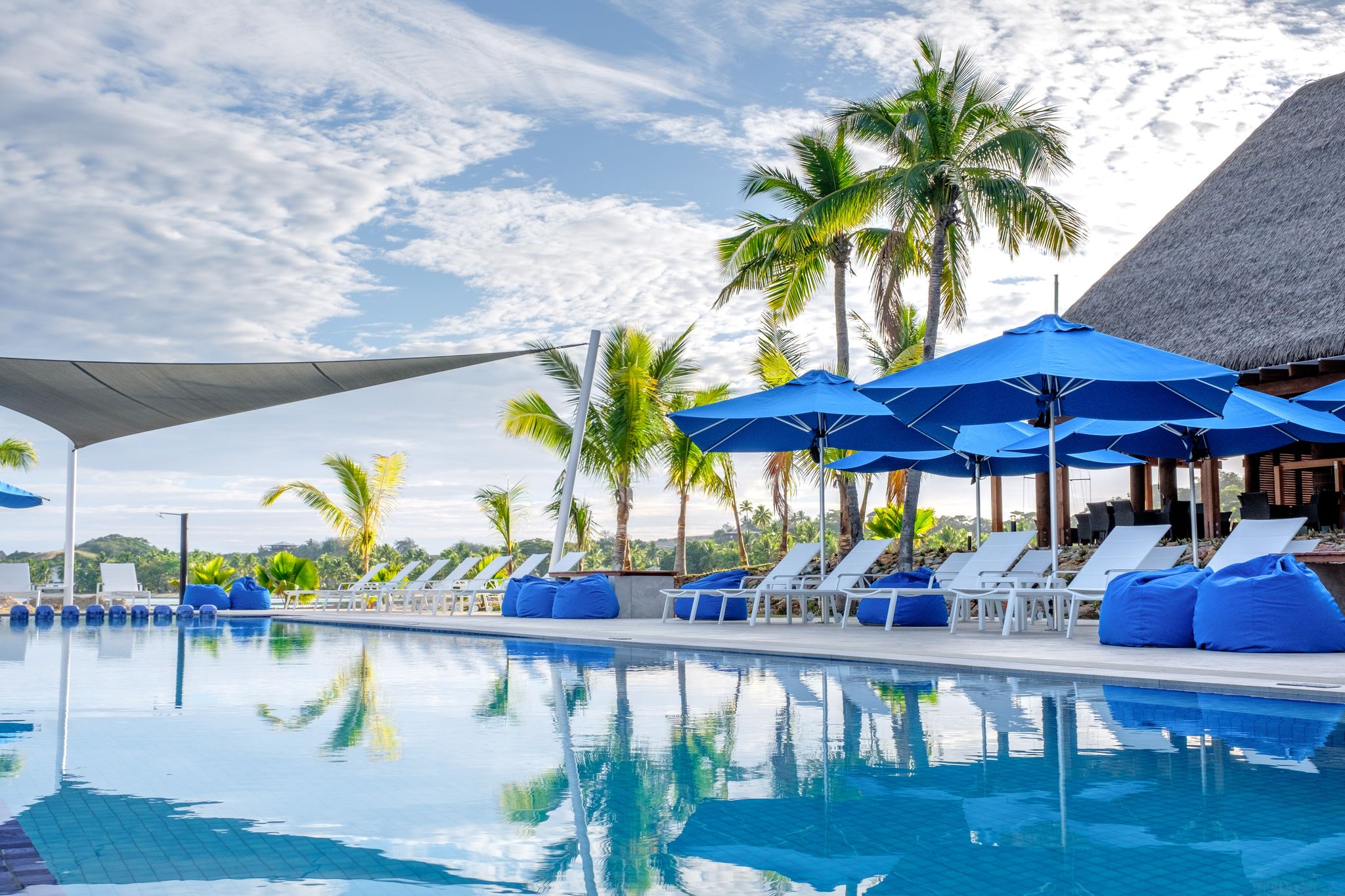 Luxurious swimming pool with a clear morning sky.